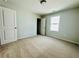 Carpeted bedroom featuring a window, closet, and neutral color scheme at 4495 Buttonwood Ln, Lilburn, GA 30047
