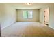 Empty bedroom featuring carpet and large windows; great for a guest room or home office at 4495 Buttonwood Ln, Lilburn, GA 30047