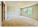 A neutral colored vacant bedroom with carpet, that is full of natural light from the windows at 4495 Buttonwood Ln, Lilburn, GA 30047