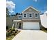 Beautiful two-story home featuring a two-car garage, a brick facade and gray siding at 4495 Buttonwood Ln, Lilburn, GA 30047