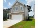 Two-story home features a two-car garage, gray siding, and well-maintained front lawn at 4495 Buttonwood Ln, Lilburn, GA 30047