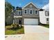 Inviting two-story home with brick accents, attached garage, and a concrete driveway at 4495 Buttonwood Ln, Lilburn, GA 30047