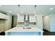 Modern kitchen with stainless steel appliances, large island, and pendant lighting at 4495 Buttonwood Ln, Lilburn, GA 30047