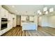 Kitchen with white cabinets, stainless steel appliances, and an island with pendant lighting at 4495 Buttonwood Ln, Lilburn, GA 30047