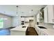 Bright, open kitchen with white cabinets, stainless steel appliances, and large island at 4495 Buttonwood Ln, Lilburn, GA 30047
