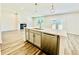 Kitchen featuring stainless steel appliances, a center island, and an open view to the fireplace at 4495 Buttonwood Ln, Lilburn, GA 30047