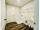 Laundry room with a utility sink, shelving, washer/dryer hookups, and wood-look flooring at 4495 Buttonwood Ln, Lilburn, GA 30047