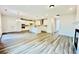 Open-concept living room with wood floors, modern fireplace, and view of the kitchen at 4495 Buttonwood Ln, Lilburn, GA 30047