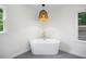 Contemporary bathroom with a standalone soaking tub and modern finishes near bright windows at 6800 Wright Rd, Atlanta, GA 30328