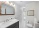 Clean bathroom featuring white marble floors and a gray vanity with a white countertop sink at 6800 Wright Rd, Atlanta, GA 30328