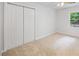Bedroom featuring bifold closet and natural lighting from large window at 6800 Wright Rd, Atlanta, GA 30328