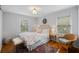 Comfortable bedroom with natural light, a decorative headboard, and a cozy seating area at 6800 Wright Rd, Atlanta, GA 30328
