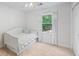 Bright bedroom features a twin bed, soft carpeting, and a sunlit window creating a cozy and inviting retreat at 6800 Wright Rd, Atlanta, GA 30328