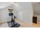 Attic exercise area with a stationary bike and neutral tones at 6800 Wright Rd, Atlanta, GA 30328