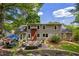 Back exterior of a home with brick chimney, patio, and lush landscaping on a sunny day at 6800 Wright Rd, Atlanta, GA 30328