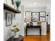 Light and airy foyer showcasing hardwood floors, decorative art, and a stylish console table with floral accents at 6800 Wright Rd, Atlanta, GA 30328