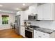 Well-equipped kitchen featuring white cabinets, stainless steel appliances, and granite countertops, offering modern functionality at 6800 Wright Rd, Atlanta, GA 30328