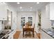 Bright kitchen featuring white cabinets, granite countertops, stainless steel appliances, and a breakfast nook at 6800 Wright Rd, Atlanta, GA 30328