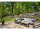 Outdoor patio space with ample seating, wooded views, and elegant landscaping at 6800 Wright Rd, Atlanta, GA 30328