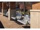 Modern park swings with decorative metal and masonry supports on a brick surface at 6800 Wright Rd, Atlanta, GA 30328