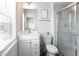 Bright bathroom featuring a white vanity and a glass-enclosed tiled shower at 135 Climbing Ivy Cir, Fayetteville, GA 30214