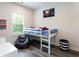 Cozy bedroom featuring a low bed with colorful bedding and natural light at 135 Climbing Ivy Cir, Fayetteville, GA 30214