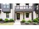 Close-up of a townhome entrance, highlighting the covered porch and neatly landscaped surroundings at 135 Climbing Ivy Cir, Fayetteville, GA 30214