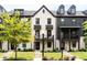 Attractive townhomes with a combination of light brick and dark siding, featuring small, inviting balconies at 135 Climbing Ivy Cir, Fayetteville, GA 30214