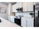 Stylish kitchen with stainless appliances, a gas range, and white cabinets at 135 Climbing Ivy Cir, Fayetteville, GA 30214