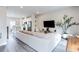 Spacious living area with contemporary furnishings, a sleek TV setup, and an open layout to the kitchen at 135 Climbing Ivy Cir, Fayetteville, GA 30214