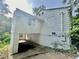 The exterior side of the house has a covered car port beneath an addition and adjacent greenery at 1440 Kenilworth Sw Dr, Atlanta, GA 30310