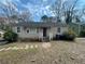 Charming one-story home with a stone pathway leading to the front door at 1440 Kenilworth Sw Dr, Atlanta, GA 30310