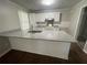 Bright kitchen features granite countertops, an island, and white cabinets for a modern look at 1440 Kenilworth Sw Dr, Atlanta, GA 30310