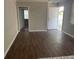 An open living room with great natural light showcases the lovely modern flooring at 1440 Kenilworth Sw Dr, Atlanta, GA 30310