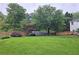Expansive backyard with mature trees, lush lawn, and a privacy fence, perfect for outdoor activities at 1885 Dayron Trce, Marietta, GA 30062