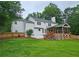 Expansive backyard showcasing the home, covered deck, firepit area, and surrounding greenery at 1885 Dayron Trce, Marietta, GA 30062