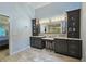 Bright bathroom featuring double sink vanity, decorative mirror, and doorway to bedroom at 1885 Dayron Trce, Marietta, GA 30062