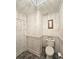 Elegant half bath with tiled floor, wainscoting, modern toilet, and stylish decor at 1885 Dayron Trce, Marietta, GA 30062