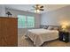 Cozy bedroom with neutral colors, a wood accent wall, and soft lighting at 1885 Dayron Trce, Marietta, GA 30062