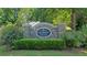Stone community entrance sign for Piedmont Chase surrounded by green bushes and trees at 1885 Dayron Trce, Marietta, GA 30062