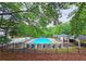 Community pool area featuring lounge chairs, tables and chairs, and shady trees at 1885 Dayron Trce, Marietta, GA 30062
