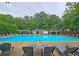 Community pool with chairs, tables, umbrellas, and shady poolside area at 1885 Dayron Trce, Marietta, GA 30062