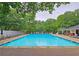 Full community pool view with chaise lounge seating, tables and chairs, and three-foot depth marker at 1885 Dayron Trce, Marietta, GA 30062