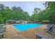 Community pool with various seating arrangements surrounded by lush trees at 1885 Dayron Trce, Marietta, GA 30062