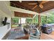 Inviting covered deck with wood ceiling, ceiling fans, and comfortable outdoor seating for relaxing at 1885 Dayron Trce, Marietta, GA 30062