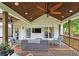 Relaxing covered deck featuring wood ceiling, ceiling fan, and comfortable outdoor furniture at 1885 Dayron Trce, Marietta, GA 30062