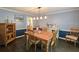 Traditional dining room featuring hardwood floors, blue walls, and an elegant light fixture at 1885 Dayron Trce, Marietta, GA 30062
