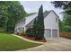 A two-story home with an attached two-car garage, well-manicured lawn, and mature landscaping at 1885 Dayron Trce, Marietta, GA 30062
