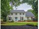 Charming two-story home with a landscaped front yard, gray shutters, and a bright blue front door at 1885 Dayron Trce, Marietta, GA 30062