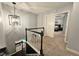 Second-floor hallway featuring an open view to a bedroom with a decorative light fixture at 1885 Dayron Trce, Marietta, GA 30062